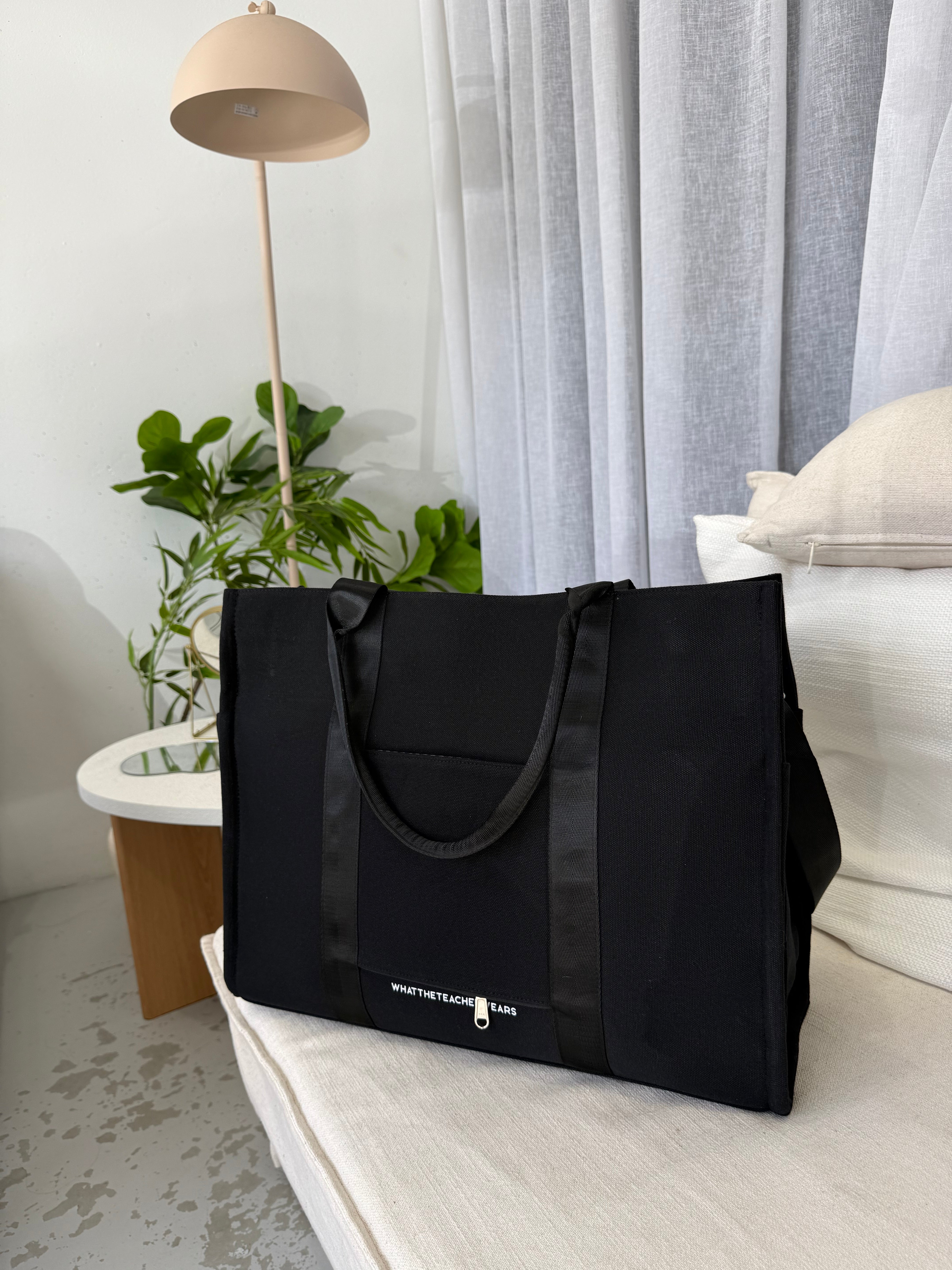 Black thick canvas tote with multiple compartments for essentials